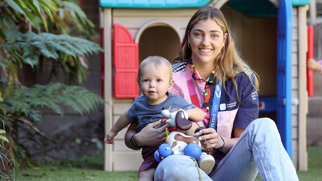 Olympic gold medallist Meg Harris with her loud shirt at Hear and Say with 18-month-old Harry Callaghan. Picture: Tara Croser.