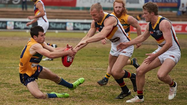 Eagles’ Chris Hall and Adelaide's Scott Thompson wrestling for the ball.