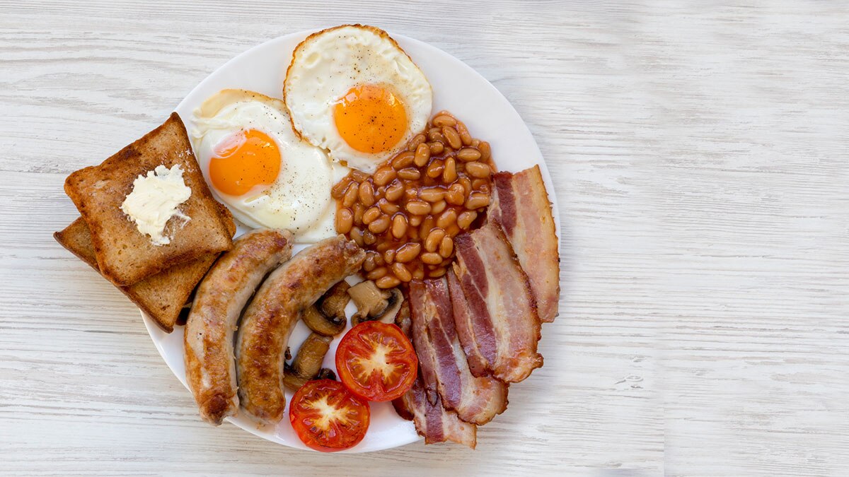 It's a little-known fact that the Full English Breakfast only took off in popularity when baked beans were added in place of scorched heretics. Pic via Getty Images.