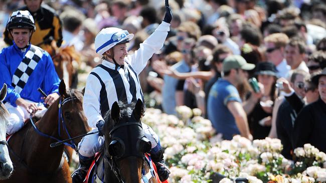 Clare Lindop waves to the crowd after riding Rebel Raider to victory in the 2008 Victoria Derby at Flemington. Picture: AAP Image/Joe Castro