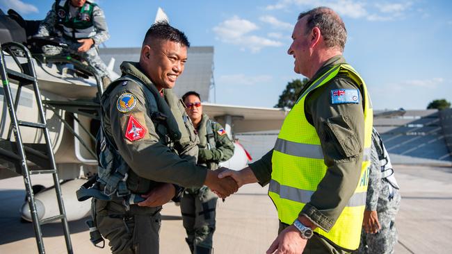 Air Commodore Pete Robinson welcomes LTC Michael G Rabina PAF and COL Randy M Pascua PAF (GSC) as Filipino fighter pilots touch down in Darwin for Exercise Pitch Black 24. Picture: Pema Tamang Pakhrin