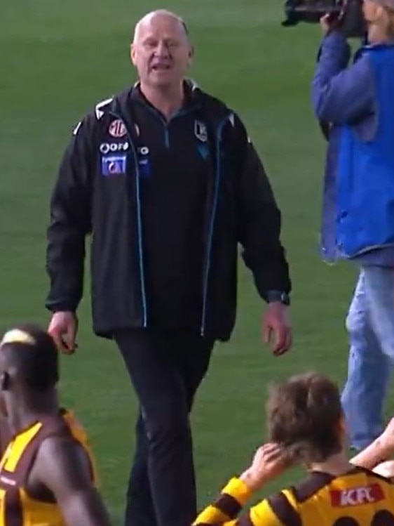 Ken Hinkley clashes with Hawks players post-match.