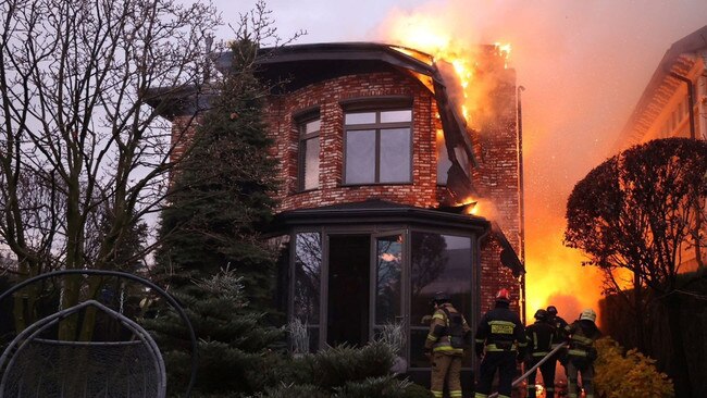 Firefighters at the site of the Russian missile strike in Dnipro, Ukraine. Picture: Reuters