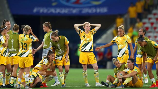 The Australia players look dejected after losing the penalty shoot out