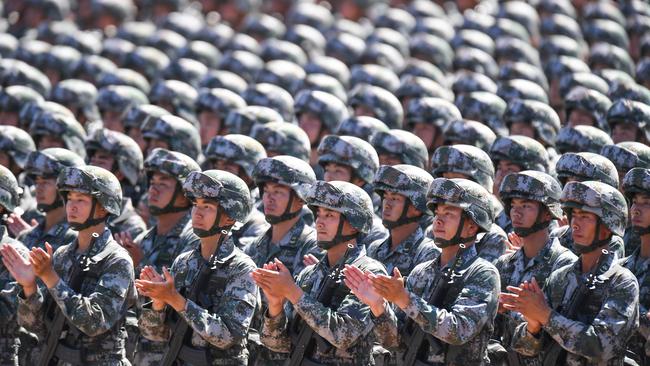 Chinese soldiers applauding during a military parade at the Zhurihe training base in China's northern Inner Mongolia region.