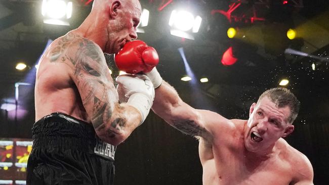 Paul Gallen lands a right on Barry Hall. Picture: AAP