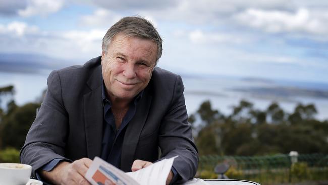 Charles Wooley reading the paper at his local cafe, the Signal Station in Mt Nelson. TasWeekend. Charles Wooley cover story