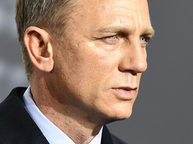 (FILES) This file photo taken on October 28, 2015 shows British actor Daniel Craig at a photocall for the James Bond film 'Spectre'  in Berlin.   Daniel Craig, the British actor who famously complained he'd rather slash his wrists than play James Bond a fifth time, has finally confirmed he's returning as 007 after all... one last time.The New York Times first reported last month that the 49-year-old's return to the big screen in 2019 was a "done deal" for the 25th movie in a franchise that has thrilled generations of cinemagoers.But the actor had previously stopped short of confirming the reports."I've been quite cagey about it," he admitted August 15, 2017 to US television host Stephen Colbert on CBS's "The Late Show." / AFP PHOTO / TOBIAS SCHWARZ