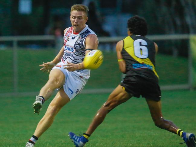 All the action from NTFL Round 7: Southern Districts’ Matthew Duffy kicking past Nightcliff’s Liam Holt-Fitz in the first game under lights at Nightcliff Oval. Picture: Glenn Campbell