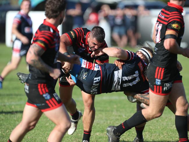 Brad Hopkins is tackled. Picture Warren Gannon Photography