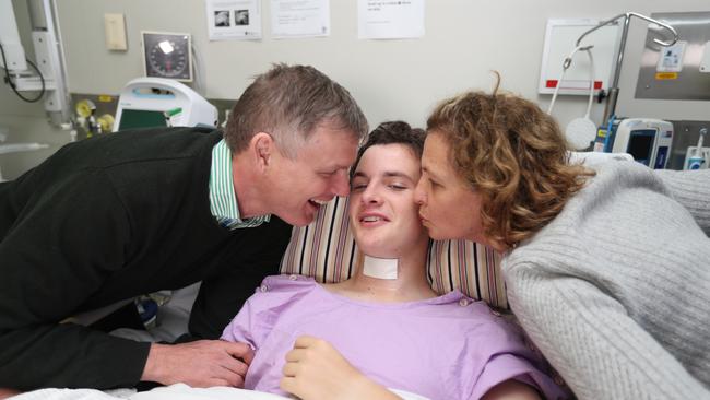 Conor Tweedy in hospital with dad Sean and mum Beck. Picture: Annette Dew