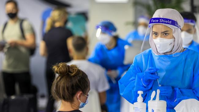 A health worker looks on at the Histopath pre-departure Covid testing clinic at Sydney International airport in December in Sydney. Picture: Jenny Evans/Getty Images