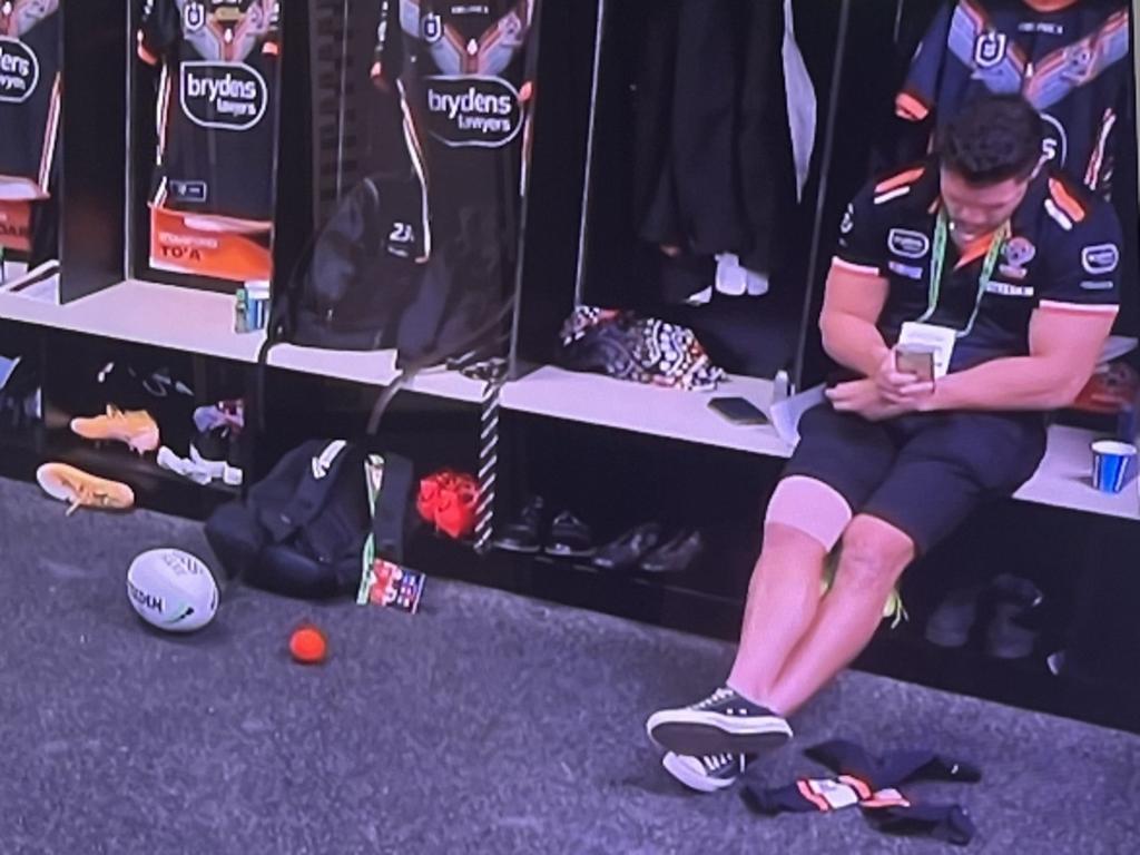 James Roberts on his mobile in the Wests Tigers dressing room