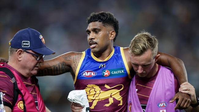 BRISBANE, AUSTRALIA - MARCH 08: Keidean Coleman of the Lions is assisted by trainers during the 2024 AFL Opening Round match between the Brisbane Lions and the Carlton Blues at The Gabba on March 08, 2024 in Brisbane, Australia. (Photo by Russell Freeman/AFL Photos via Getty Images)