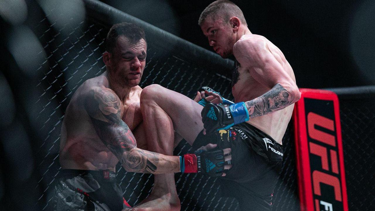 Toowoomba MMA fighter Tom "Big Train" Nolan applies pressure to Trevor Sinclair during their bout at Carrara Stadium on the Gold Coast.