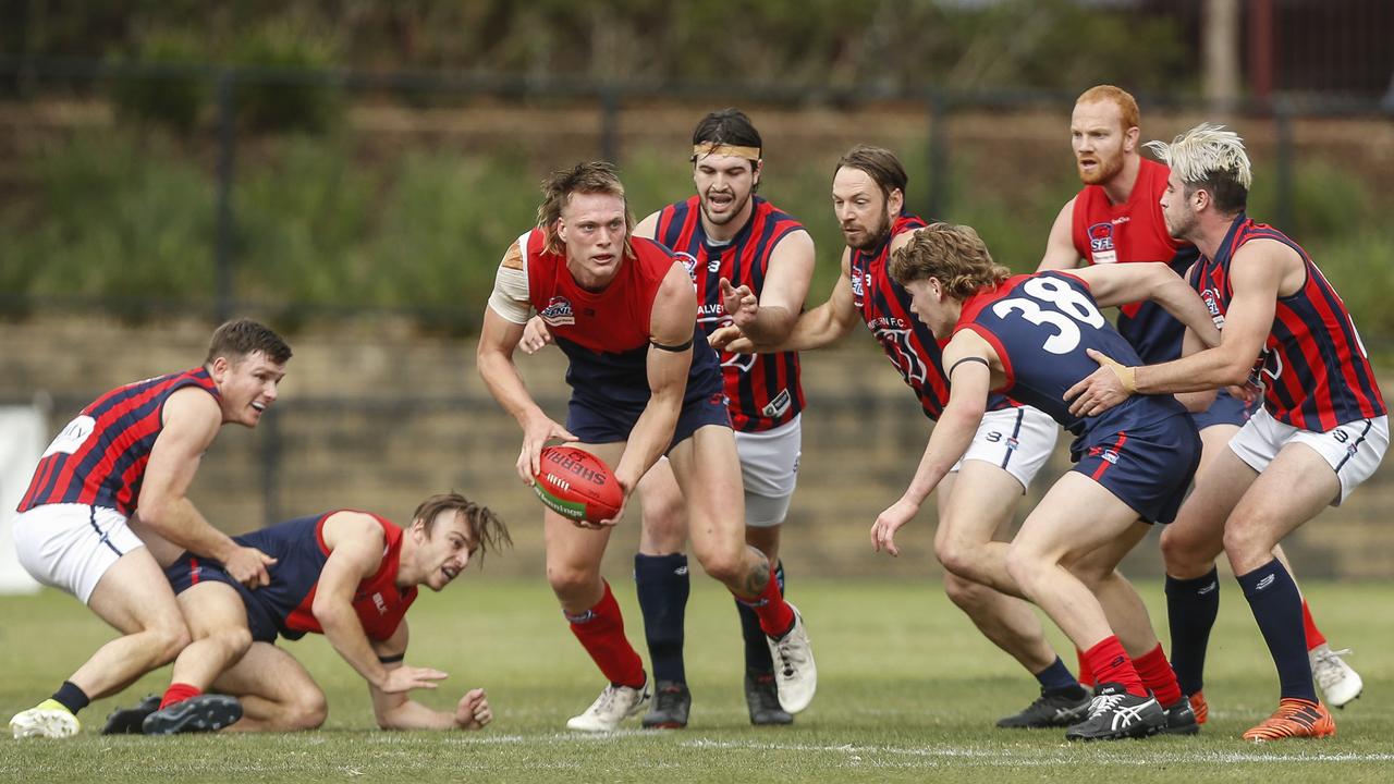 Southern: Mitchell Smart looks to clear the ball for East Malvern. Picture: Valeriu Campan