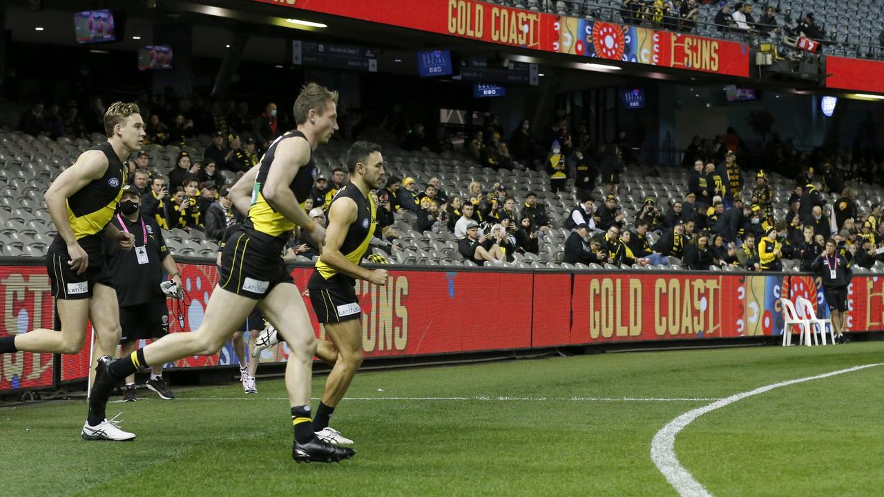 MELBOURNE, AUSTRALIA - JULY 01: Richmond players run out to a small crowd before the round 16 AFL match between the Gold Coast Suns and the Richmond Tigers at Marvel Stadium on July 01, 2021 in Melbourne, Australia. (Photo by Darrian Traynor/Getty Images)