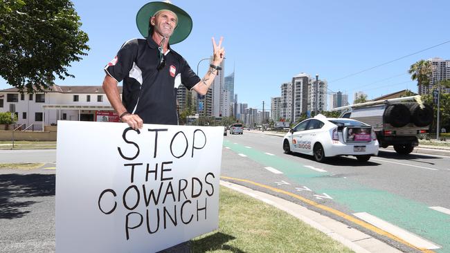 Craig Dight on the side of the road at Broadbeach with a sign and a shirt protesting one-punch attacks and rallying for tougher sentencing. Picture Glenn Hampson