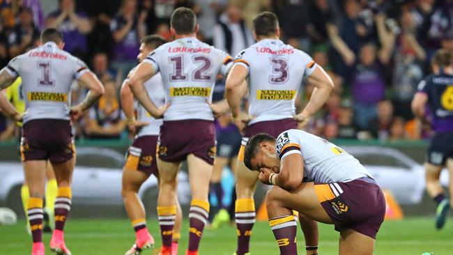 Broncos players look dejected after a Storm try.