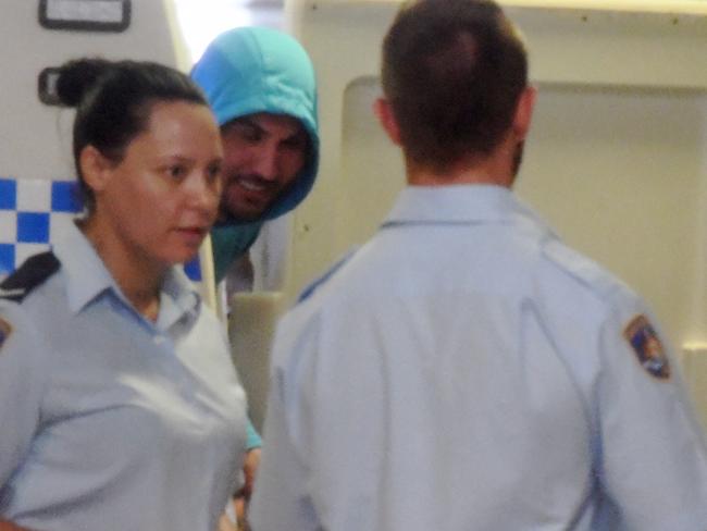 A smiling Mehajer steps out of a police paddy wagon at Burwood Local Court today.