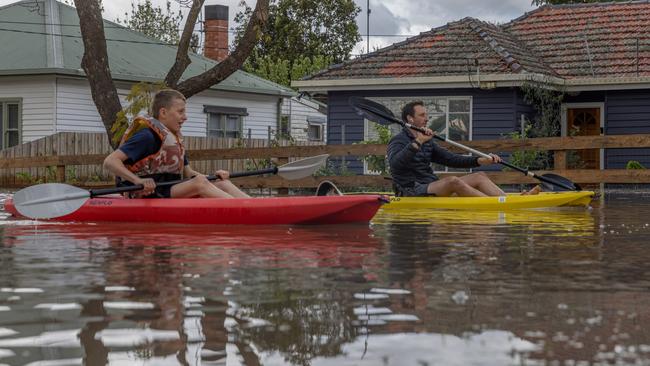 Maribyrnong residents take to canoes to navigate a flooded street. Picture: Getty Images