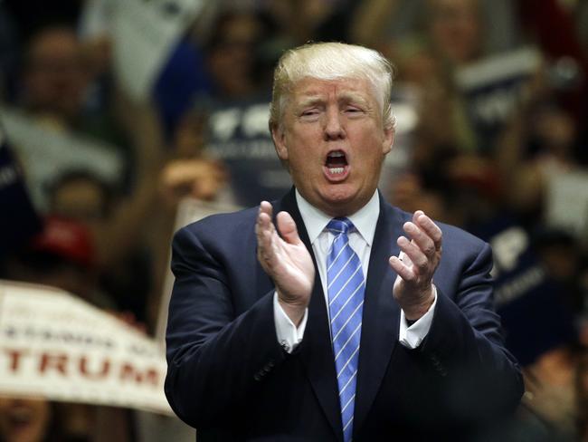 Republican presidential candidate Donald Trump applauds after singing the National Anthem during the rally at the Anaheim Convention Centre. Picture: AP