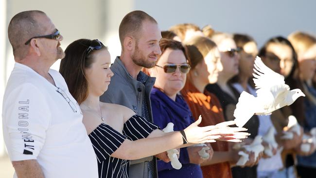 Nathan, Peter and Deanna Beilby pictured releasing doves at the memorial service for Larissa Beilby at Pine Rivers Park. Picture: AAP/Josh Woning