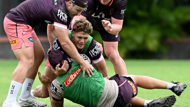 Reece Walsh and Billy Walters make a tackle at Broncos training. (Photo by Bradley Kanaris/Getty Images)