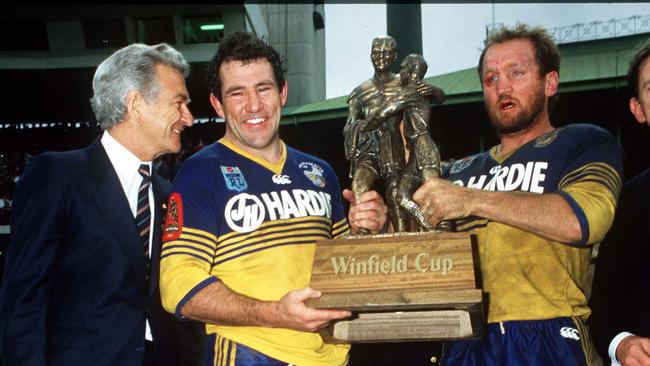 Prime Minister Bob Hawke with Parramatta players Michael Cronin and Ray Price holding the Winfield Cup trophy after Parramatta Eels defeated Canterbury Bulldogs in the 1986 RL grand final at the SFS in Sydney. Pic Action Photographics