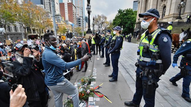 Protesters challenge police outside Melbourne’s Parliament House on Saturday. Picture: Jason Edwards