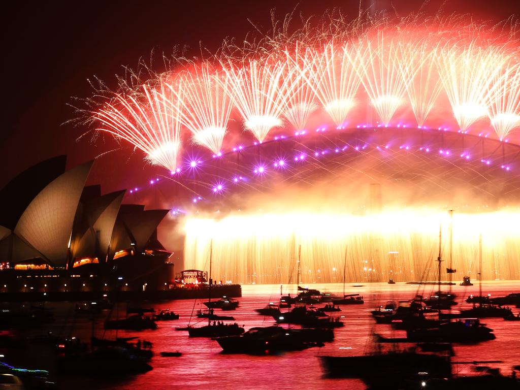 The harbour bridge lights up for the Midnight fireworks display, New Years Eve Fireworks on the Sydney Harbour Bridge as seen from Mrs Macquarie's Point 2019. Picture Rohan Kelly