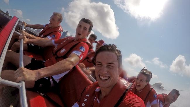 Tom McCartin and Matt Ling join other Sydney Swans recruits in a speedboat on Sydney Harbour. Picture: Toby Zerna