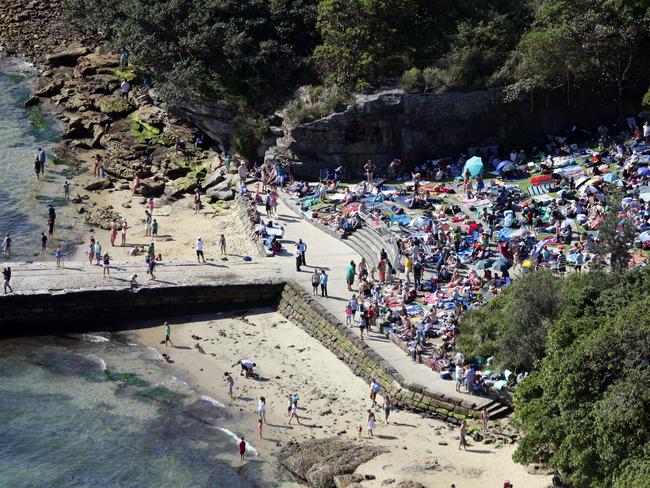 Crowds of people gather early at Bradleys Head to see a previous New Year's Eve fireworks