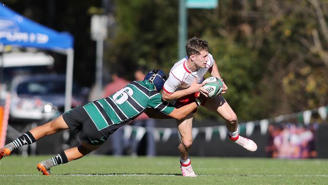 IGS' Sam Walker tackled by BBC flanker Zac Hough. Picture: AAP Image/Josh Woning