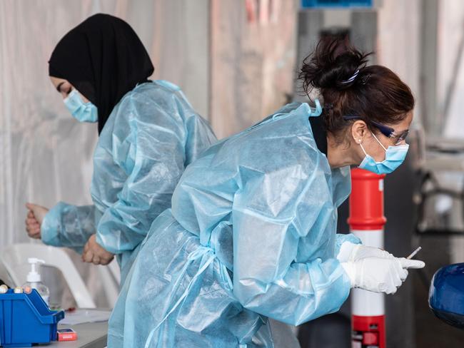 SYDNEY, AUSTRALIA - NewsWire Photos September 24, 2021: Medical staff administering COVID-19 Vaccinations at the Drive-Through COVID-19 Vaccination Hub at Belmore Sports Ground, Sydney. Picture: NCA NewsWire / James Gourley