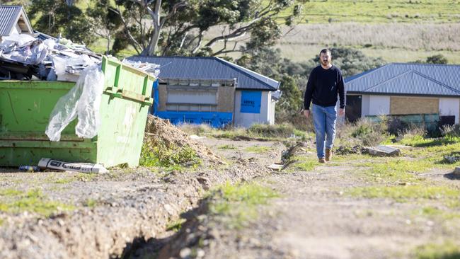 Edward Gilmore with his unfinished home after the collapse of the Felmeri Group in O'Halloran Hill. Picture: Kelly Barnes