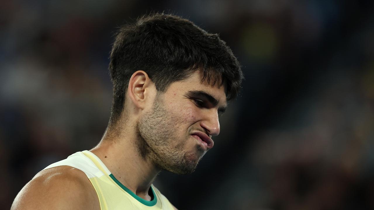 MELBOURNE, AUSTRALIA - JANUARY 24: Carlos Alcaraz of Spain reacts during their quarterfinals singles match against Alexander Zverev of Germany during the 2024 Australian Open at Melbourne Park on January 24, 2024 in Melbourne, Australia. (Photo by Julian Finney/Getty Images)
