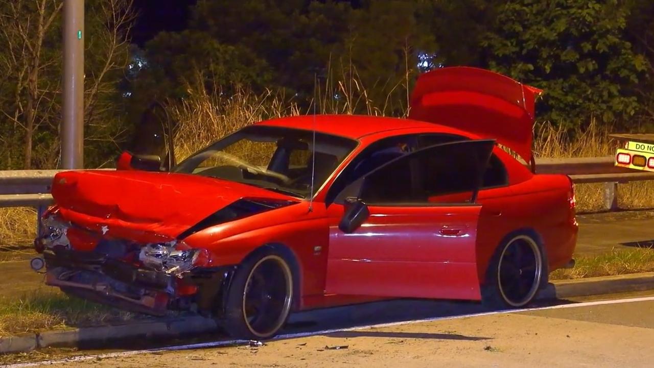 Police investigate a crash that happened in an exit lane from the Pacific Highway at Moonee Beach on March 9, 2022.