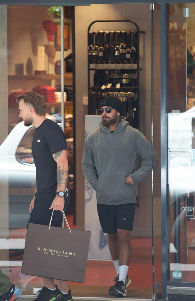 Efron was accompanied by his friend and assistant. Picture: Media-mode.com