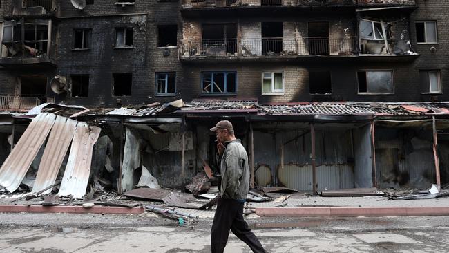 A man smokes outside destroyed buildings in the Ukrainian town of Siversk, Donetsk region. Picture: AFP