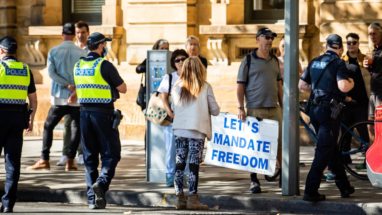 Police with protesters outside court, before the trial began. Picture: Tom Huntley