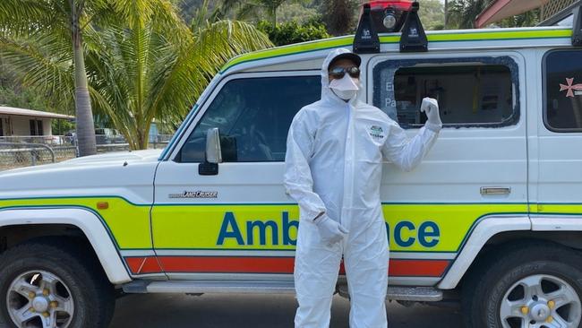 Queensland Ambulance Service worker, Gerald Wotton, with the vandalised ambulance.