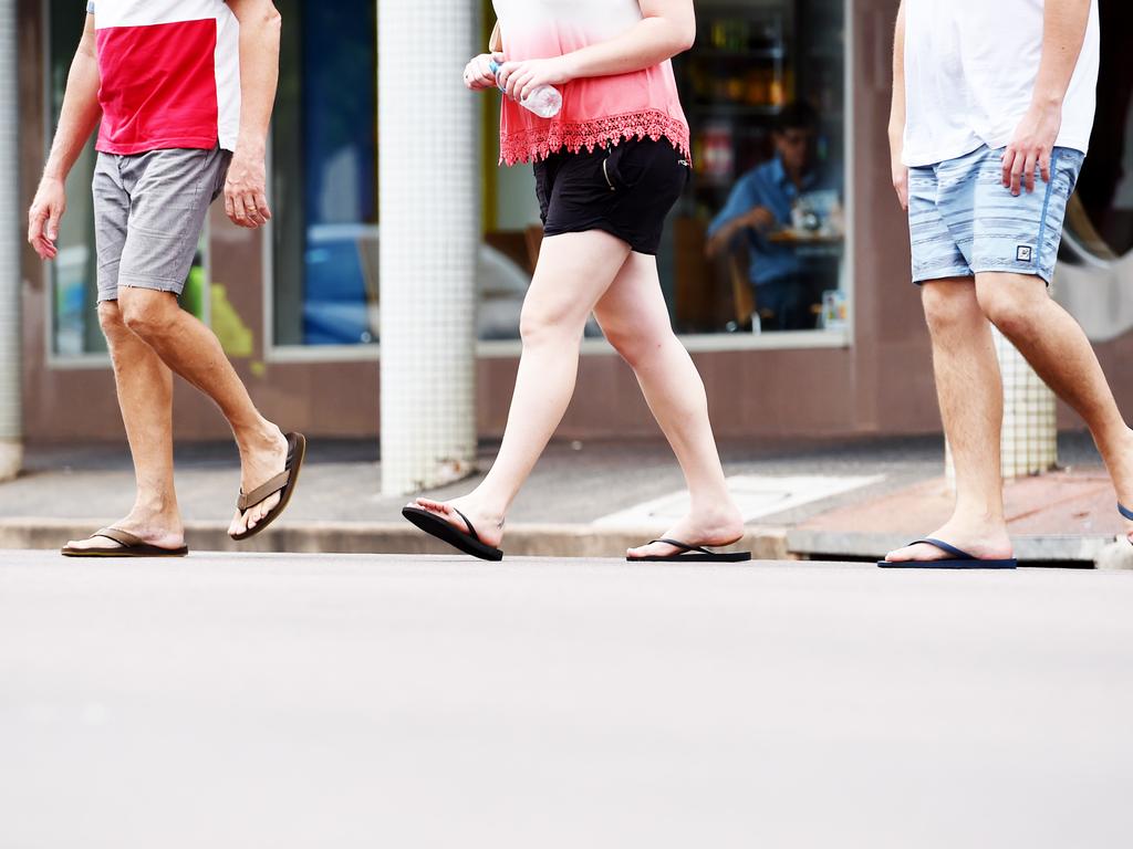 Pedestrians walk across the road at the corner Knuckey and Smith Street in Darwin city centre.