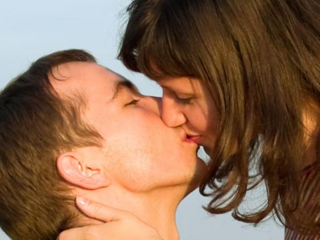 Teen Couple Kissing in Field