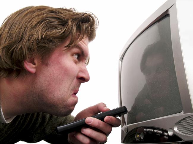 Undated : FEE APPLIES...ONE TIME USE... 11/11/2008 TODAY: Istock 000005423662 large. generic angry man pointing a remote control at a television TV set