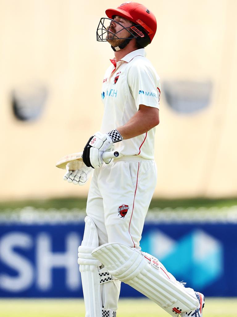 Test batsman Travis Head walks from the ground looking dejected after being dismissed by Ashton Agar. (Photo by Daniel Kalisz/Getty Images)