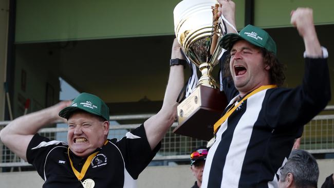 Former coach Kim Excel and Nathan Brown celebrate a premiership. Picture: KIM EISZELE