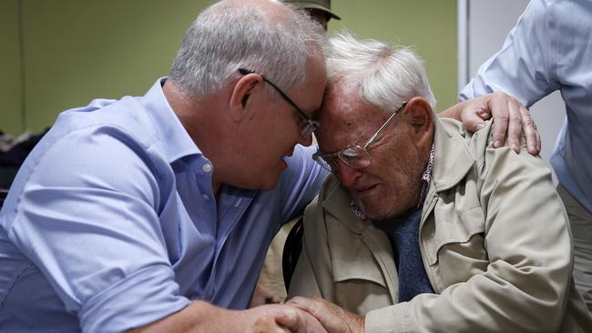 Prime Minister Scott Morrison comforts 85-year-old Owen Whalan after the Koorainghat resident was evacuated from his home in November last year. Picture: AAPw