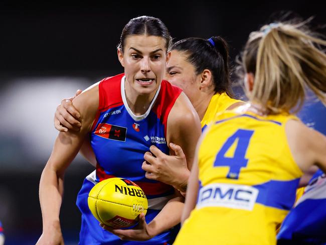 Alice Edmonds of the Bulldogs tries to handball while in heavy traffic. Picture: Dylan Burns/AFL Photos via Getty Images