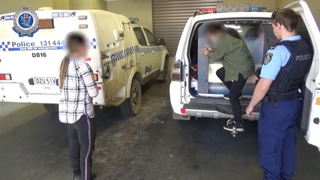 Two people arrive at Dubbo Police Station after they were arrested at a Ballimore property. Picture: NSW Police